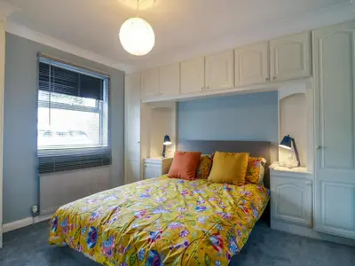 a bedroom with a bed with a colorful comforter at The Annex in Colchester