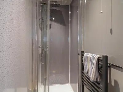 a shower with a glass door in a bathroom at The Annex in Colchester