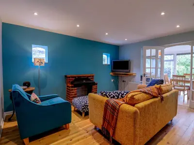 a living room with a couch and a fireplace at The Annex in Colchester
