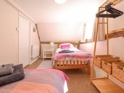 a small bedroom with a bed and a ladder at 3 The Almshouse in Saxmundham