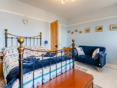 a bedroom with a bed and a couch at Beachcombers Retreat in Felixstowe