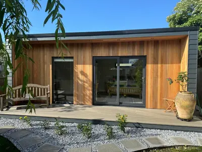 a small house with a deck with a patio at Gorgeous studio! in Cherry Hinton