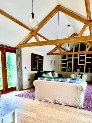 a living room with a couch and a table at Oak Grange holiday cottage in Hoxne