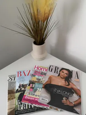 a magazine sitting on a table with a plant at Cosy Central Home, Sleeps 5 by Homes by Jacq in Colchester