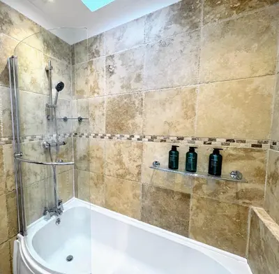 a bathroom with a shower and a bath tub at Cosy Central Home, Sleeps 5 by Homes by Jacq in Colchester