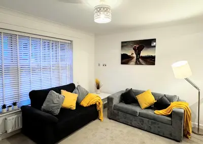 a living room with two couches and a window at Cosy Central Home, Sleeps 5 by Homes by Jacq in Colchester