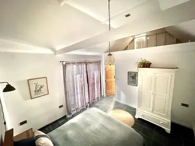 a living room with a bed and a window at Mersea best kept secret in Colchester