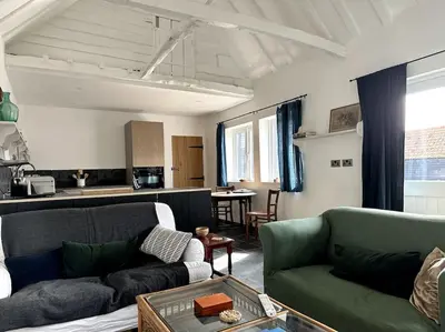 a living room with two couches and a kitchen at Mersea best kept secret in Colchester