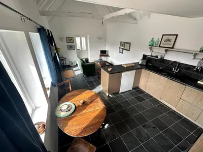 a kitchen with a wooden table in a room at Mersea best kept secret in Colchester
