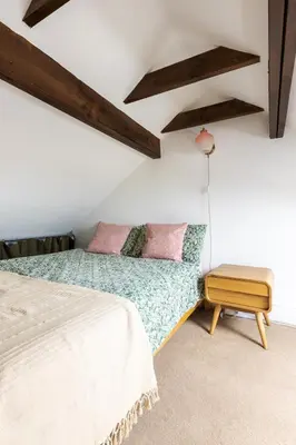 a bedroom with a bed and a table at En-suite with double bed on mezzanine and desk in family home in Hertford