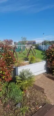 a park with a playground with a swing set at Rose Manor in Little Clacton