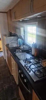 a kitchen with a stove and a counter top at Rose Manor in Little Clacton