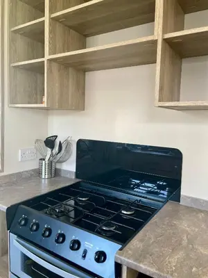 a stove top oven sitting in a kitchen at Caravan at Seawick Holiday Park Close to Beach in Saint Osyth