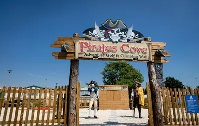 a sign for the pirates cove amphibious court and entry yard at Caravan at Seawick Holiday Park Close to Beach in Saint Osyth
