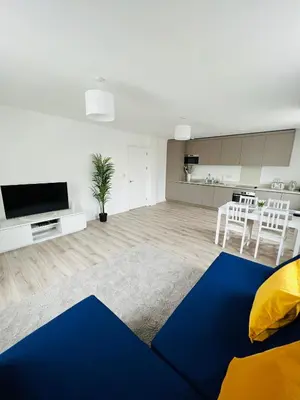 a living room with a blue and yellow rug at Stunning New Penthouse Apartment in Southend-on-Sea