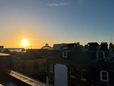 a sunset over a city with buildings and roofs at Stunning New Penthouse Apartment in Southend-on-Sea