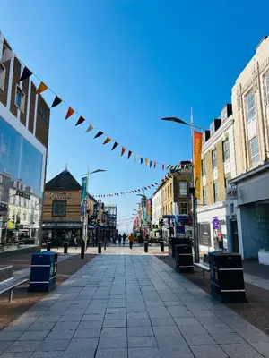 a street in a city with a bunch of flags at Stunning New Penthouse Apartment in Southend-on-Sea