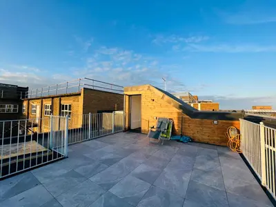 a balcony of a building with a patio at Stunning New Penthouse Apartment in Southend-on-Sea