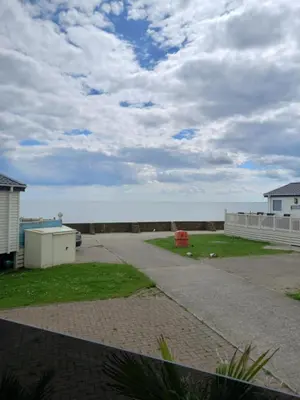 a view of the ocean from a driveway at 2 bedroom Mini Lodge Caravan at Coopers Beach Holiday Park in East Mersea