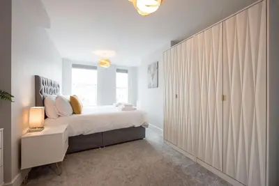 a bedroom with a large bed and a large closet at Modern,Bright and spacious 2 bed in Brentwood
