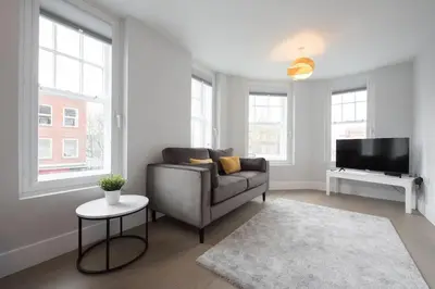 a living room with a couch and a tv at Modern,Bright and spacious 2 bed in Brentwood