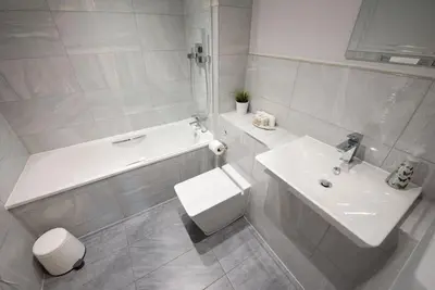 a bathroom with a sink and a tub and a toilet at Modern,Bright and spacious 2 bed in Brentwood