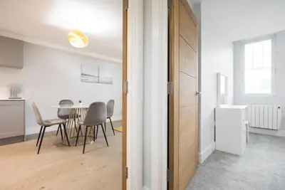 a kitchen and dining room with a table and chairs at Cosy, Bright and Spacious Flat in Brentwood