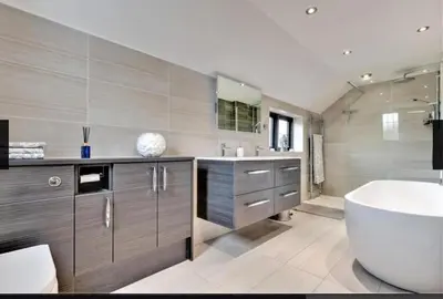 a bathroom with a tub and a sink and a bath tub at Home by the Sea in Clacton-on-Sea