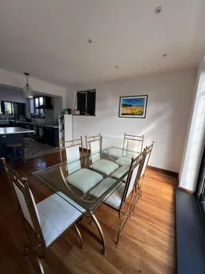 a dining room with a glass table and chairs at Home by the Sea in Clacton-on-Sea