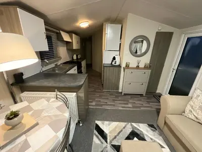 a small kitchen and living room in a tiny house at Seaview Caravan 2 Bedroom Sleeps 6 -WiFi -Smart Tv in Colchester