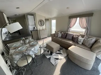 a living room with a couch and a table at Seaview Caravan 2 Bedroom Sleeps 6 -WiFi -Smart Tv in Colchester