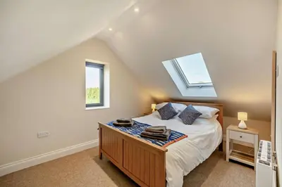 a bedroom with a bed and a skylight at 2 Bed in Feering oc-p29293 in Feering