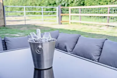 a metal bucket sitting on a table with a couch at 2 Bed in Feering oc-p29293 in Feering