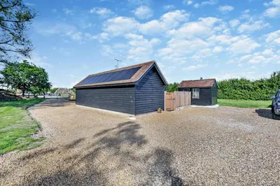 a barn with a metal roof on a gravel driveway at 2 Bed in Feering oc-p29293 in Feering