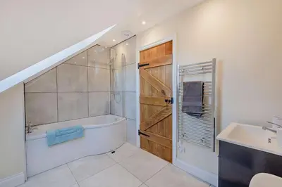 a bathroom with a bath tub and a sink at 2 Bed in Feering oc-p29293 in Feering