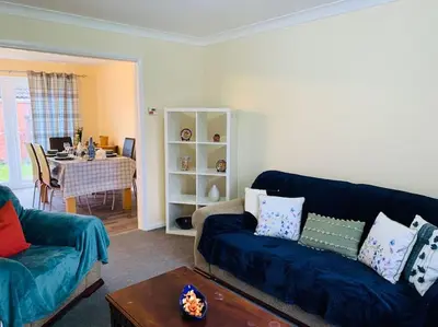 a living room with a couch and a table at Contractors and families welcome in Earith