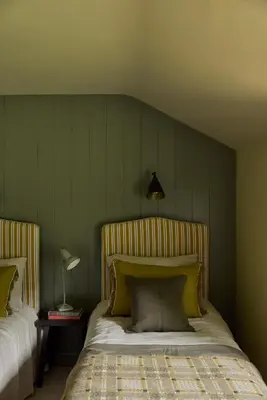 a bedroom with two beds with green walls at Restaries at Paradise Farm in Halesworth