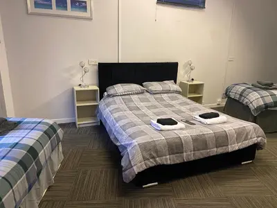 a bedroom with two beds with towels on them at The Dairy in Takeley
