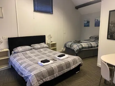 a bedroom with two beds and a table and a table at The Dairy in Takeley