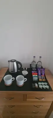 a counter with two pots and pans on a table at Carolines rooms in Cherry Hinton