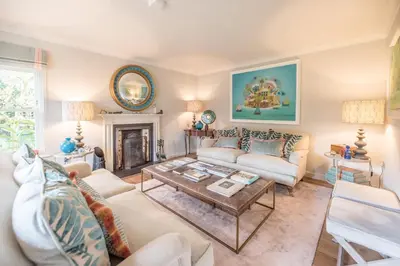 a living room with a couch and a table at Little Fig in Aldeburgh