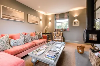 a living room with a couch and a table at Little Fig in Aldeburgh