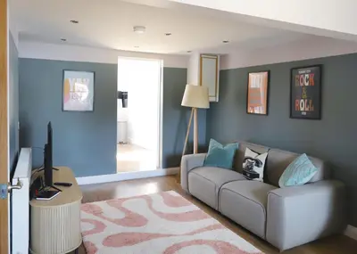 a living room with a couch and a tv at Stylish 3x bed house in Soham in Soham