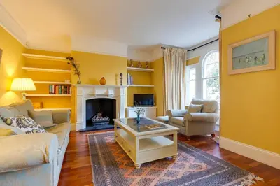 a living room with a couch and a fireplace at Pass the Keys Spacious Victorian Home with Free Parking in Cambridge