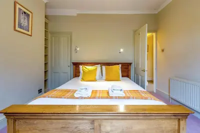 a bedroom with a bed with two towels on it at Pass the Keys Spacious Victorian Home with Free Parking in Cambridge