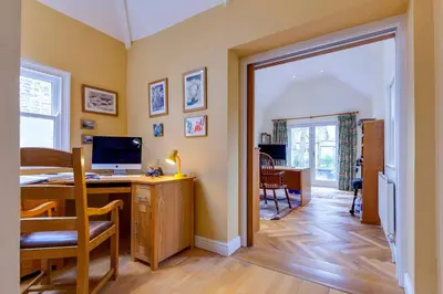 a home office with a desk with a computer on it at Pass the Keys Spacious Victorian Home with Free Parking in Cambridge