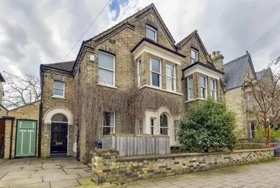 an old brick house with a green door at Pass the Keys Spacious Victorian Home with Free Parking in Cambridge