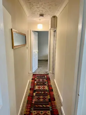 a hallway with a rug on the floor at Casa di Qeis a double bedroom ground floor flat with free parking in Chesterton
