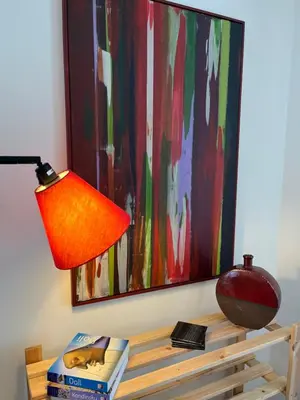 a lamp sitting on a table next to a painting at Casa di Qeis a double bedroom ground floor flat with free parking in Chesterton