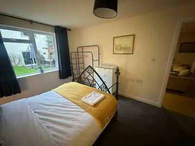 a bedroom with a bed and a window at 1 bed annex with extra sofa bed ideal for families and business guests in Littleport